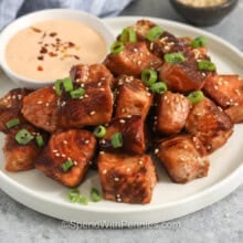 Salmon Bites on a plate with dipping sauce.