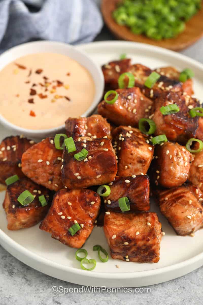 Salmon Bites on a white plate with dipping sauce.